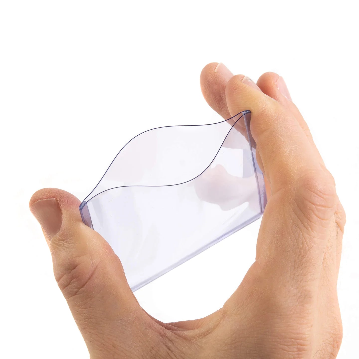 Hand holding a clear plastic bag with a white background
