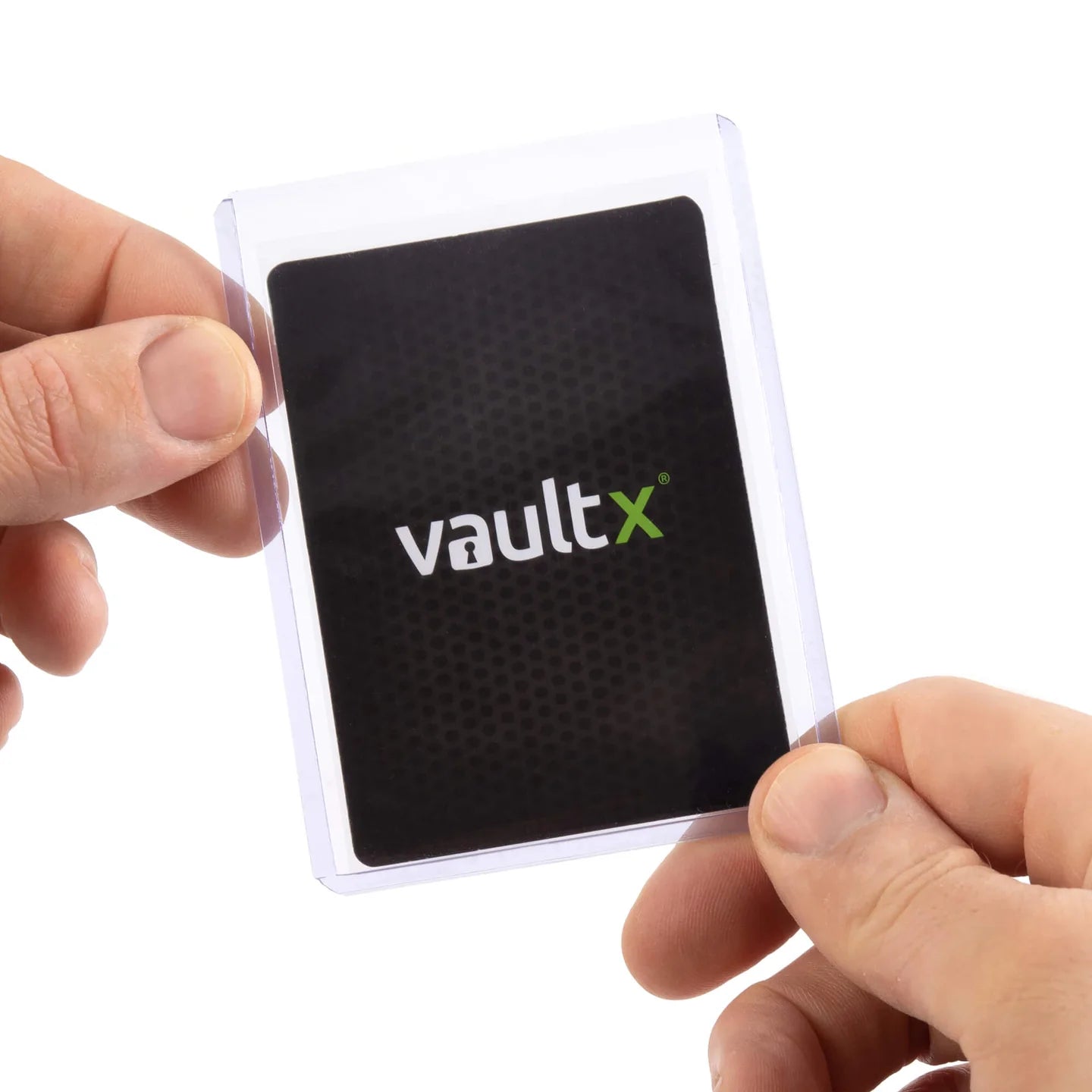 Hand holding a black card with 'vaultx' logo against a white background